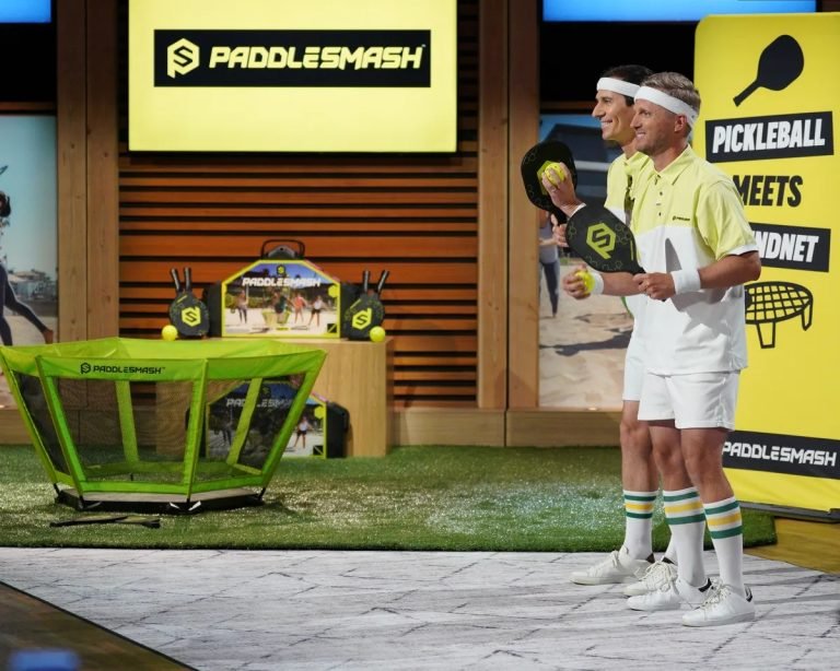 PaddleSmash Shark Tank Episode 4 Update & Net Worth PaddleSmash, a new and innovative outdoor game that combines elements of Pickleball and Spikeball, made an exciting appearance on Shark Tank during Season 15, Episode 4, which aired on October 20, 2023. The game, which comes with a net system, a foldable court, paddles, and two balls, is designed for 2 to 4 players. Each match lasts about 15 minutes, providing fast-paced, competitive fun for players of all ages. During their pitch, founders Tim Swindle and Scott Brown sought $250,000 for 10% equity in their company. After some intense negotiations, they secured a deal with Sharks Mark Cuban and Robert Herjavec for $250,000 for 20% equity. Since their appearance on the show, PaddleSmash has seen a significant increase in interest and sales, contributing to its growing success. As of April 2024, PaddleSmash has an estimated net worth of $1.2 million. What is PaddleSmash? How Does it Work? PaddleSmash is a new outdoor game that ingeniously combines the best elements of two popular sports: Pickleball and Spikeball. The game includes a net system, a foldable court, paddles, and two balls, allowing for versatile play setups. It’s designed for 2 to 4 players and can be played in small spaces, making it perfect for backyards, parks, and other recreational areas. The rules of PaddleSmash are straightforward. Players use the paddles to hit the ball over the net, similar to Pickleball, but with the added twist of bouncing the ball off the net, as in Spikeball. Each match is fast-paced, lasting about 15 minutes, making it ideal for those looking for a quick and engaging game. The game’s portability and ease of setup have contributed to its popularity, especially among families and groups looking for a fun, new outdoor activity. PaddleSmash Shark Tank Episode 4 Season 15: What Happened at Shark Tank Pitch? During their appearance on Shark Tank Season 15, Episode 4, founders Tim Swindle and Scott Brown introduced PaddleSmash to the Sharks. They asked for $250,000 in exchange for 10% equity, valuing their company at $2.5 million. The founders explained that PaddleSmash was a new and exciting outdoor game that had already gained traction in the market. The landed cost of the product was $55, and it was being sold for $199.99. The founders revealed that the company had been in business for just 9 months but had already achieved $700,000 in sales. They also mentioned a royalty agreement with Joe Bingham, the inventor of the game, who receives a 5% royalty on net sales. The Sharks were impressed with the product's potential, but the conversation quickly turned to the company’s valuation. Kevin O’Leary initially offered $250,000 for 20% equity at a $1.2 million valuation. However, Mark Cuban and Robert Herjavec teamed up to offer the same amount for the same equity stake. After some back-and-forth, the founders accepted the offer from Cuban and Herjavec, securing the investment they needed to grow their business. PaddleSmash Shark Tank Pitch Summary Company Name PaddleSmash Founder Tim Swindle, Scott Brown, Joe Bingham Product New Outdoor Game Amount Asked For $250,000 for 10% equity Final Deal $250,000 for 20% equity Investor Mark Cuban, Robert Herjavec Season & Episode (USA) Season 15, Episode 4 Lifetime Sales $1 million estimated Business Status In Business Current Net Worth $1.2 million estimated What Happened to PaddleSmash After Shark Tank? After securing a deal with Mark Cuban and Robert Herjavec on Shark Tank, PaddleSmash experienced a surge in sales and interest. The exposure from the show significantly boosted the company’s visibility, leading to increased orders from customers eager to try out the new game. The company also benefited from the expertise and resources of its new investors, which helped in refining their marketing strategy and expanding their reach. The investment allowed PaddleSmash to scale its operations, particularly in terms of inventory and social media marketing. The game is now available on major retail platforms, including Amazon, Dicks Sporting Goods, Scheels, and Academy Sports + Outdoors, as well as on the company’s official website. This expansion has solidified PaddleSmash's position in the competitive outdoor games market. How Much Is PaddleSmash Worth? As of 2024, PaddleSmash is estimated to be worth $1.2 million. This valuation reflects the company’s rapid growth since its launch in 2022 and its success in securing a deal on Shark Tank. The game’s strong profit margins, combined with the growing popularity of outdoor recreational activities, have positioned PaddleSmash as a promising player in the industry. Is PaddleSmash Still in Business? Yes, PaddleSmash is still in business and continues to thrive. The company has maintained its momentum following its Shark Tank appearance, expanding its customer base and solidifying its market presence. With the backing of Mark Cuban and Robert Herjavec, PaddleSmash is well-positioned to continue its growth and introduce even more people to this exciting new game. Which Episode & Season Number Was PaddleSmash on Shark Tank? PaddleSmash was featured on Shark Tank during Season 15, Episode 4, which aired on October 20, 2023. In this episode, the founders, Tim Swindle and Scott Brown, successfully secured a deal with Mark Cuban and Robert Herjavec for $250,000 in exchange for 20% equity in their company. ________________________________________ Frequently Asked Questions Who are the founders of PaddleSmash? PaddleSmash was founded by Tim Swindle, Scott Brown, and Joe Bingham. Joe Bingham is the inventor of the game. What is PaddleSmash? PaddleSmash is a new outdoor game that combines elements of Pickleball and Spikeball, designed for 2 to 4 players. It includes a net system, a foldable court, paddles, and two balls. Did PaddleSmash get a deal on Shark Tank? Yes, PaddleSmash secured a deal with Mark Cuban and Robert Herjavec for $250,000 for 20% equity. How much is PaddleSmash worth? As of 2024, PaddleSmash is estimated to be worth $1.2 million. Is PaddleSmash still in business? Yes, PaddleSmash is still in business and continues to grow. Which episode of Shark Tank featured PaddleSmash? PaddleSmash was featured on Shark Tank Season 15, Episode 4.
